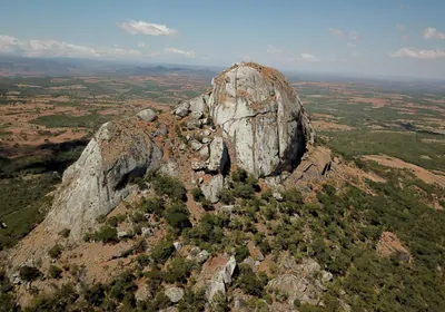 rock formation rising out of a plain